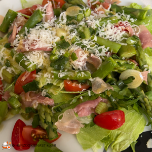 Green asparagus salad with bacon and fresh green salad and tomatoes