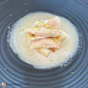 Poached chicken breast with white asparagus and chocolate. Sauce unfortunately too little bound - you can see on the black plate
