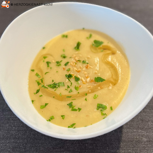 Cauliflower and potato soup in a white bowl